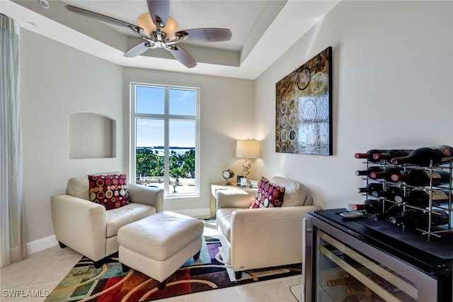 interior space featuring light tile patterned floors, ceiling fan, and baseboards