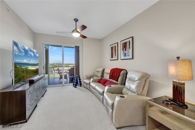 living area featuring a ceiling fan and light colored carpet