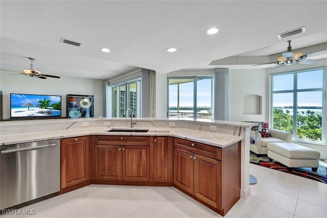 kitchen with open floor plan, stainless steel dishwasher, a sink, and visible vents