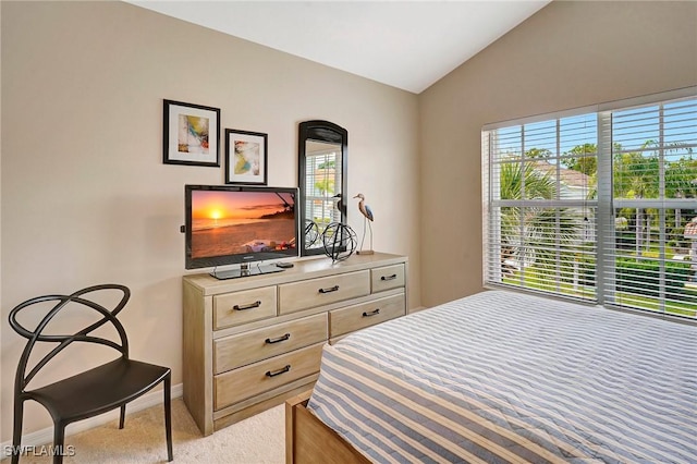 bedroom featuring baseboards, vaulted ceiling, and light colored carpet