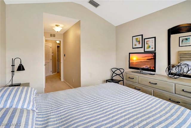 bedroom featuring vaulted ceiling, light carpet, visible vents, and baseboards