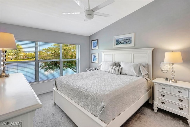 bedroom with light carpet, vaulted ceiling, and a ceiling fan