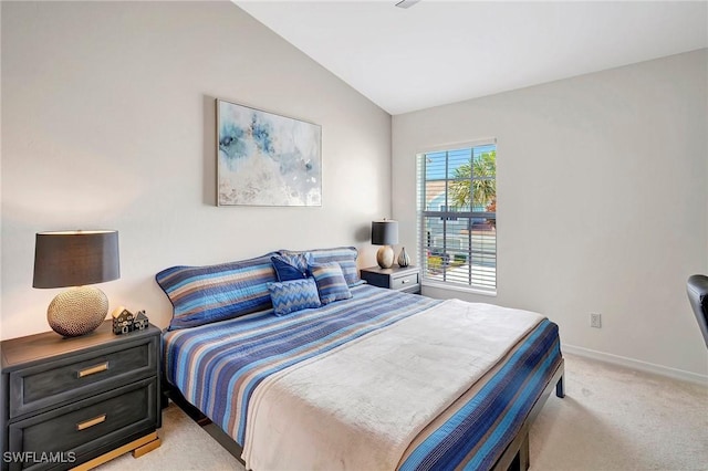 bedroom featuring lofted ceiling, baseboards, and light colored carpet