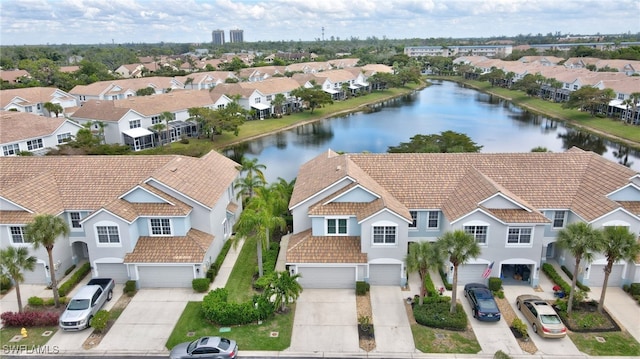 birds eye view of property with a water view and a residential view