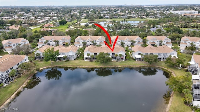 drone / aerial view with a water view and a residential view