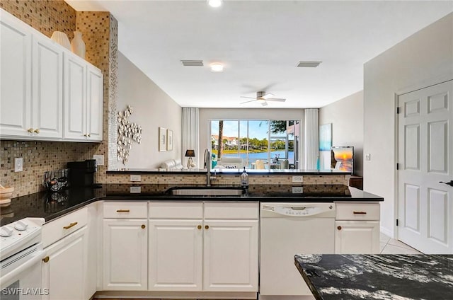 kitchen with white appliances, ceiling fan, white cabinetry, and a sink