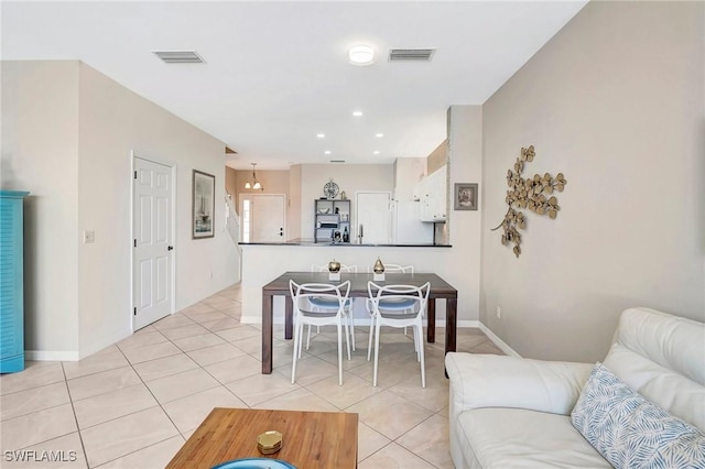 living room featuring visible vents, baseboards, and light tile patterned floors