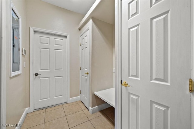 mudroom with light tile patterned floors and baseboards