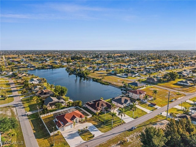 birds eye view of property with a residential view and a water view