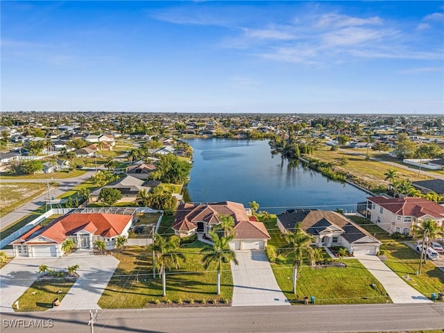 drone / aerial view with a residential view and a water view