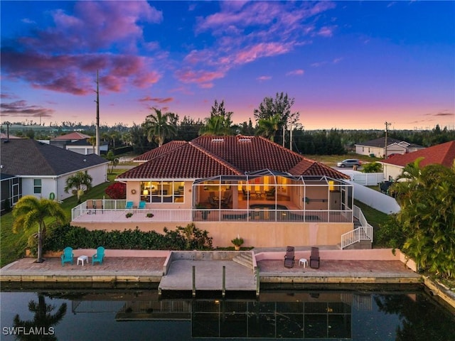 back of property featuring a patio, a tiled roof, fence, and stucco siding