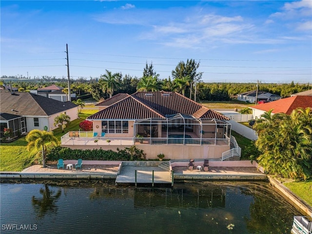 rear view of house featuring stucco siding, a water view, a patio, a lanai, and a tiled roof