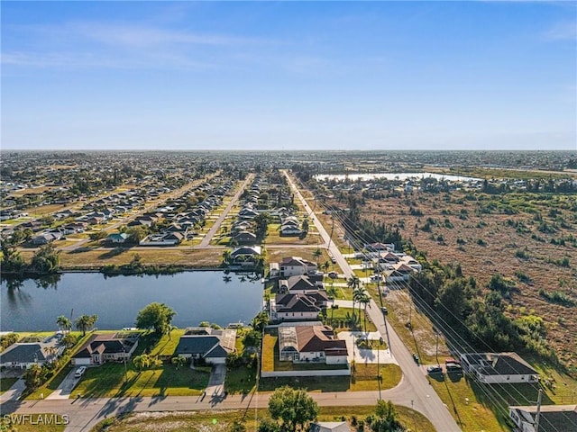 birds eye view of property with a residential view and a water view