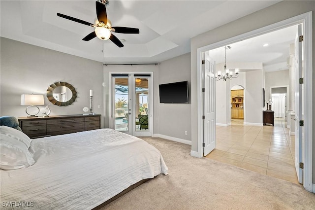 bedroom featuring a tray ceiling, light tile patterned floors, baseboards, light colored carpet, and access to exterior