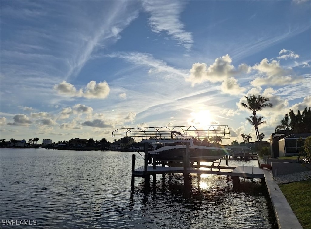 dock area with a water view and boat lift