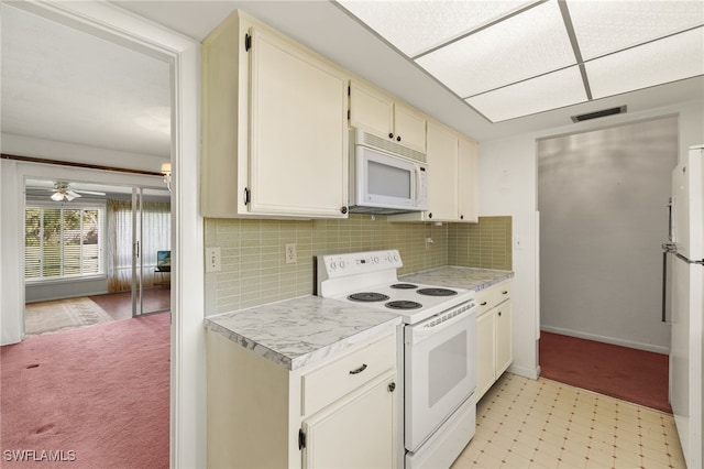 kitchen with white appliances, visible vents, light countertops, light floors, and backsplash