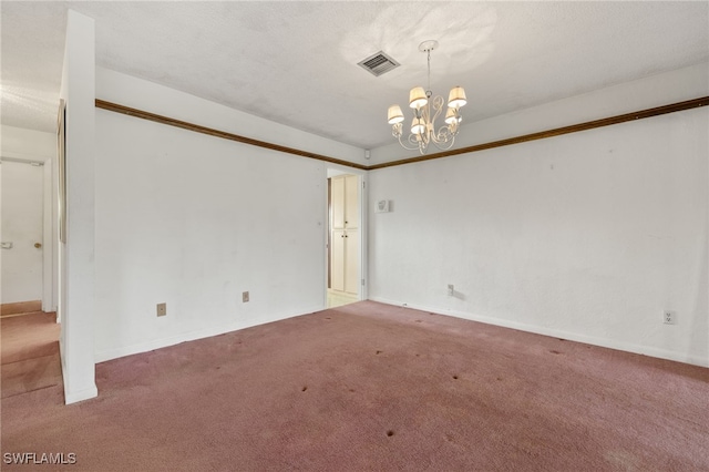 unfurnished room featuring an inviting chandelier, carpet, visible vents, and a textured ceiling