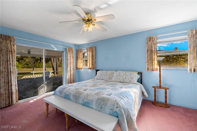 carpeted bedroom with access to outside, ceiling fan, and a textured ceiling