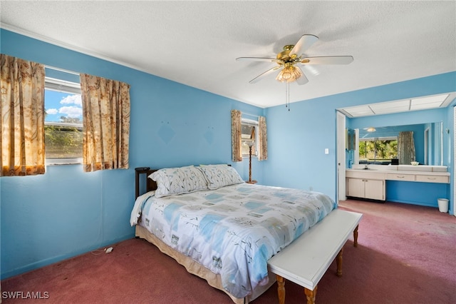 bedroom with carpet, ceiling fan, and a textured ceiling