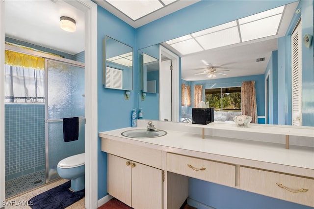 full bath with visible vents, a ceiling fan, toilet, vanity, and a shower stall