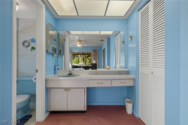 bathroom featuring ceiling fan, toilet, a closet, and vanity