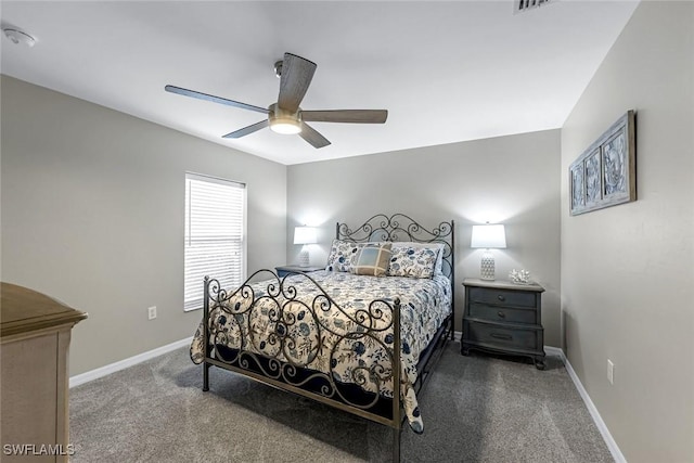 carpeted bedroom with a ceiling fan, visible vents, and baseboards