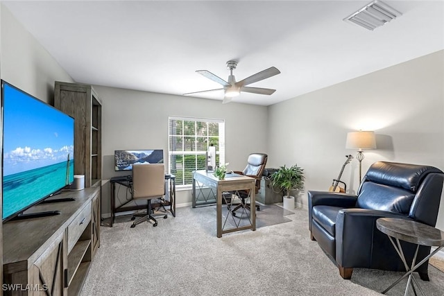 office area featuring light carpet, ceiling fan, visible vents, and baseboards