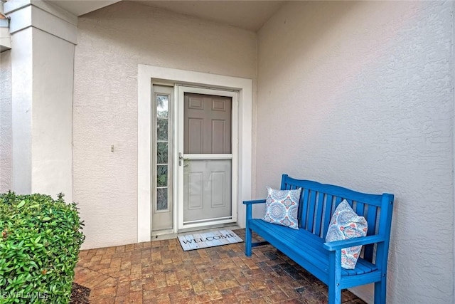 view of exterior entry with stucco siding