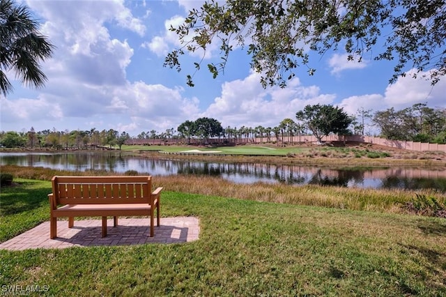 exterior space featuring a lawn and a water view