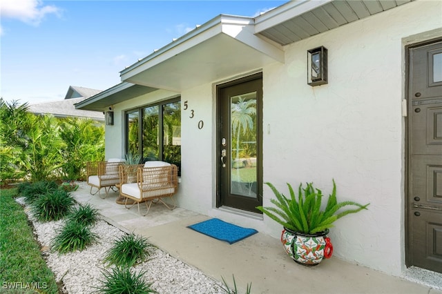 entrance to property with stucco siding