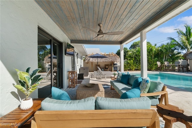 view of patio / terrace featuring a fenced in pool, ceiling fan, and an outdoor living space