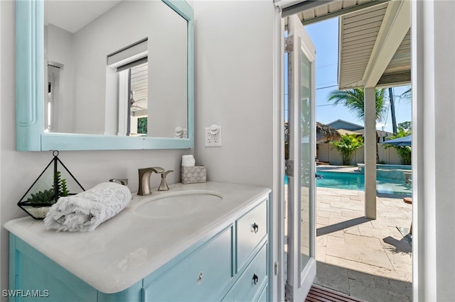 bathroom with stone tile flooring and vanity