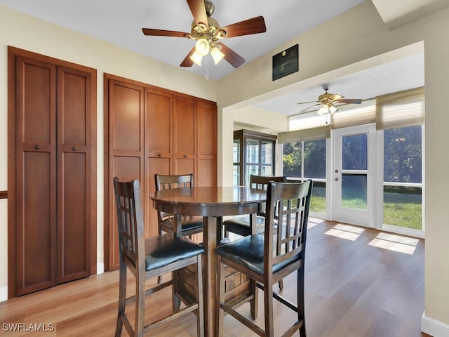 dining space featuring light wood finished floors and a ceiling fan