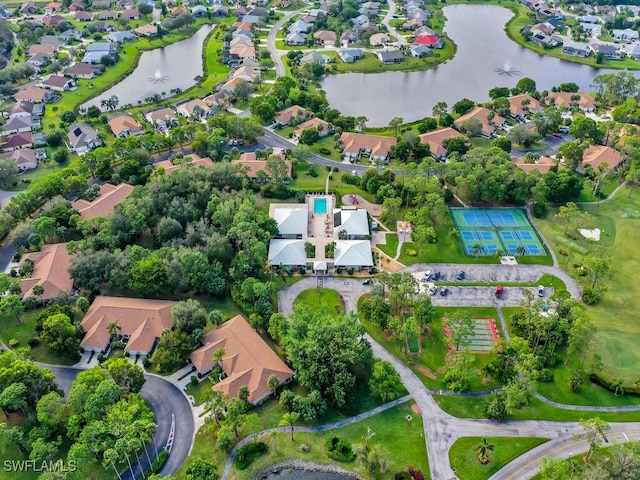 birds eye view of property with a water view and a residential view