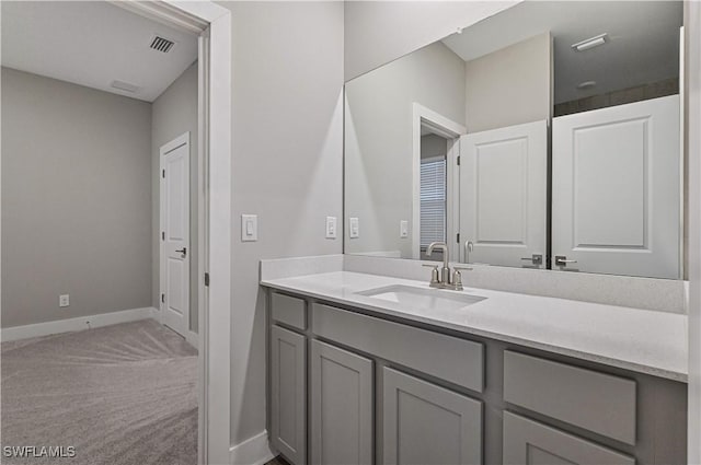 bathroom with baseboards, visible vents, and vanity