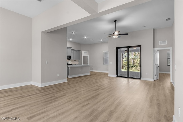 1705 SW 13th St, Cape Coral, FL 33991 - unfurnished living room featuring a sink, light wood-style flooring, a ceiling fan, baseboards, and recessed lighting