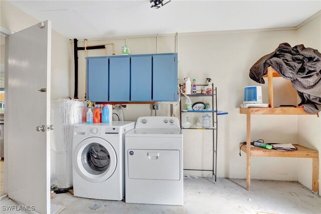 washroom featuring cabinet space and independent washer and dryer