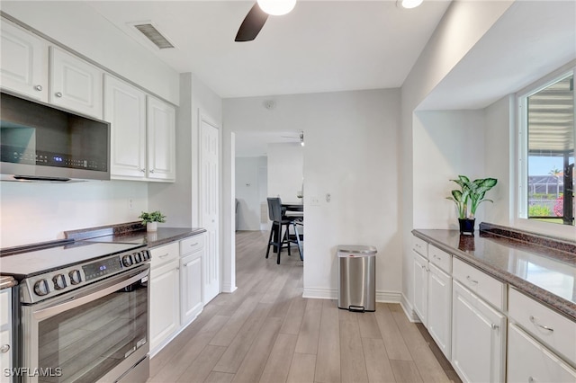 kitchen with white cabinets, light wood-style flooring, visible vents, and stainless steel appliances