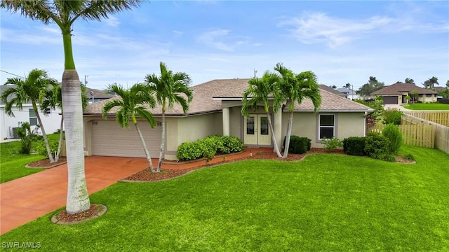 single story home with french doors, stucco siding, concrete driveway, an attached garage, and fence