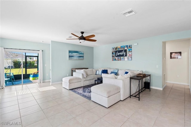 living room featuring light tile patterned floors, baseboards, visible vents, and a ceiling fan