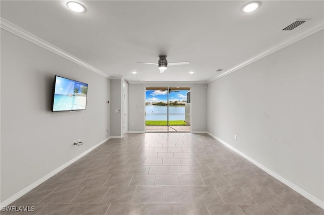 empty room featuring baseboards, visible vents, ceiling fan, and crown molding