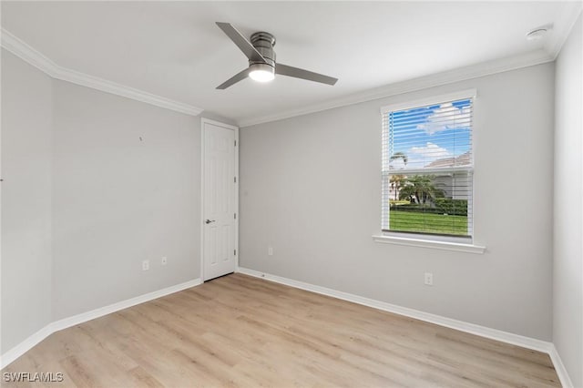 empty room featuring light wood-style floors, baseboards, ornamental molding, and a ceiling fan