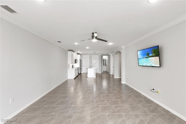 unfurnished living room with a ceiling fan, arched walkways, visible vents, and crown molding