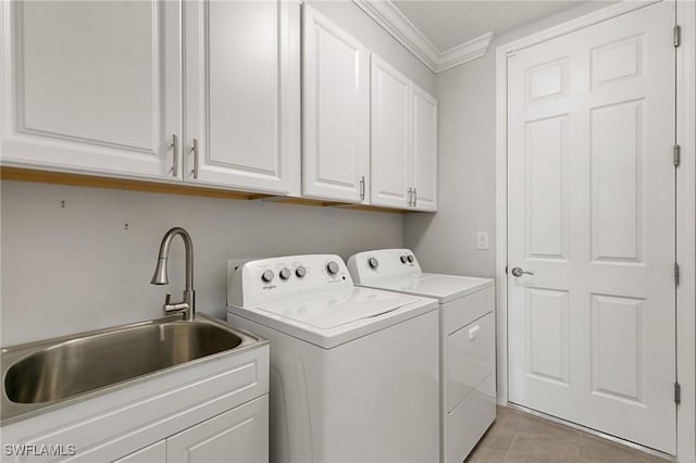 clothes washing area featuring light tile patterned floors, a sink, ornamental molding, cabinet space, and washing machine and clothes dryer