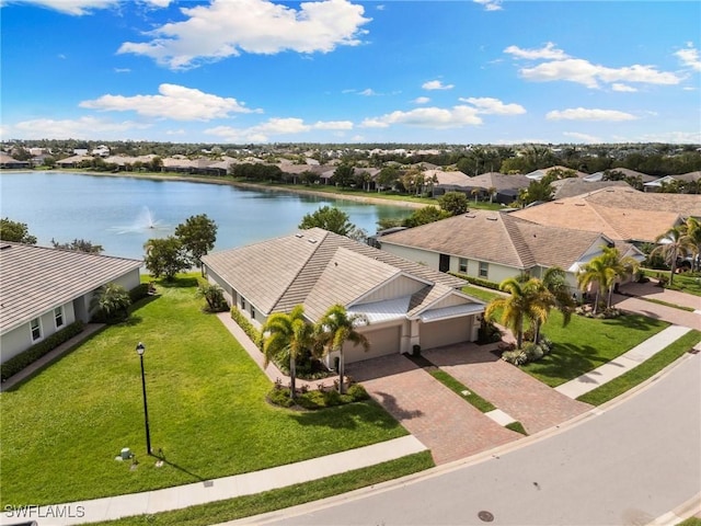 drone / aerial view with a water view and a residential view