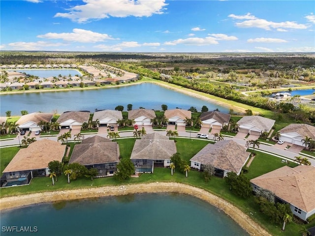 birds eye view of property with a residential view and a water view