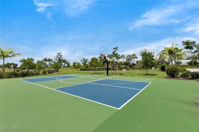 view of sport court featuring a yard, community basketball court, and fence