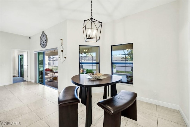 dining room with baseboards, a chandelier, and light tile patterned flooring