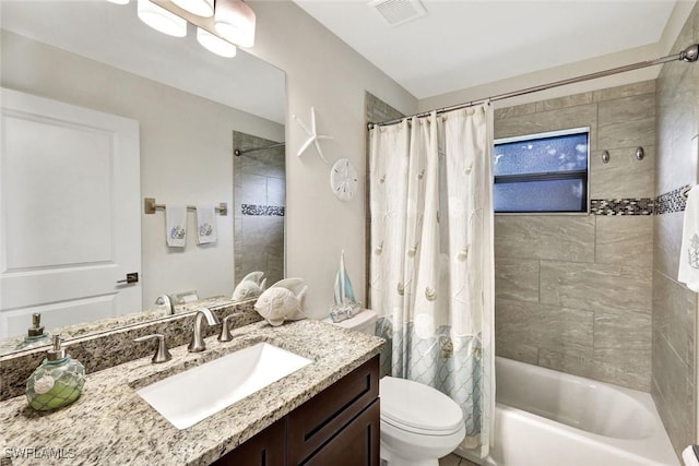 bathroom with shower / bath combo, visible vents, vanity, and toilet