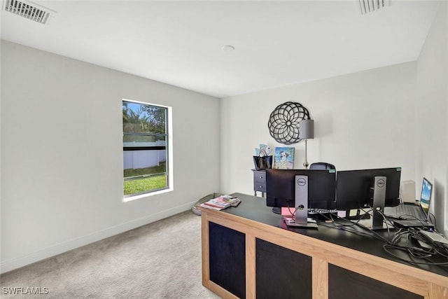 carpeted home office with visible vents and baseboards